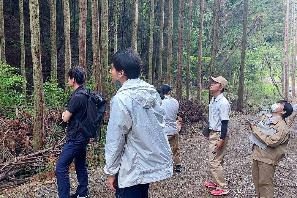 地域の方の説明を真剣に聞く生徒たち