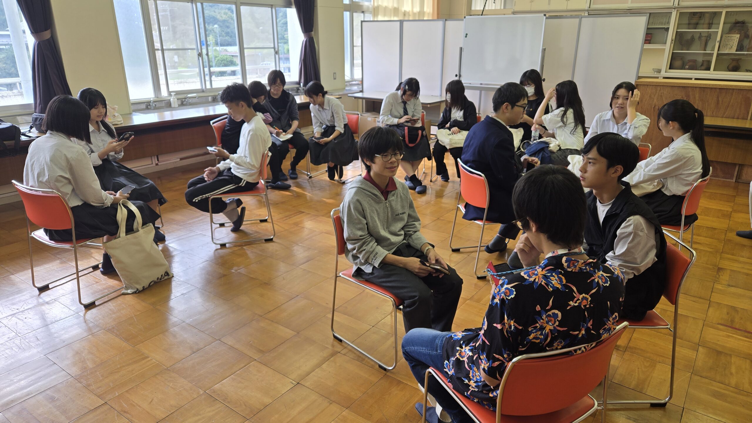三和小学校の理科室で現地視察後の振り返りを行う高校生たち
